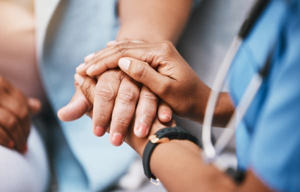 Doctor and senior patient hands representing Medicare guidance